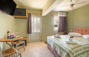 a bedroom with two beds and a table and a table at Limonero New City Apartment 2 with Private Parking in Lefkada Town