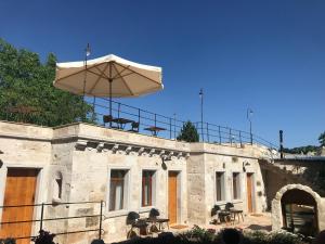 a building with an umbrella on top of it at Sarnich Cave Suites in Goreme