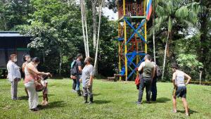 a group of people standing around in a park at Cabañas alto del aguila in Puerto Nariño