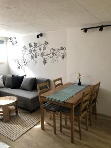 a living room with a table and a couch at Sklípek-chatka Bella Moravia in Dobré Pole