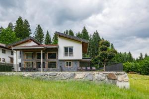 a house with a stone wall in front of it at Chalet Isabella in Kaltenbach