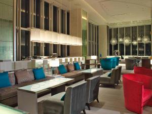 a restaurant with couches and tables and chairs at Osaka Marriott Miyako Hotel in Osaka