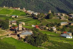 an aerial view of a small village in the mountains at Shorena's Homestay in Tsvirmi