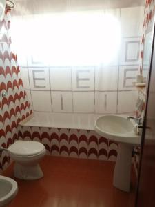 a bathroom with a toilet and a sink at Frontemare 6 posti letto in Borgo +5 photos
