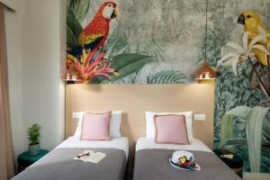 two beds in a room with a painting on the wall at Majestic Villa-Apartments in Darmarochori