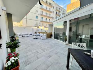an outdoor patio with a table and chairs on a building at Matthew's Home B&B in Peschici