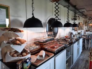 a kitchen filled with lots of different types of food at Beachhotel Sahlenburg - Adults Only - Boutiquehotel in Cuxhaven