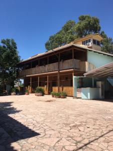 a large building with a stone driveway in front of it at Pension Maria in Lefkada Town