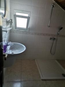 a bathroom with a sink and a shower with a window at Sirius star otel in Ortaca