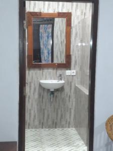 y baño con lavabo y espejo. en Bali Senia Hotel, en Sanur