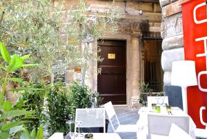 a pair of tables and chairs in front of a door at Palazzo Cambiaso in Genoa