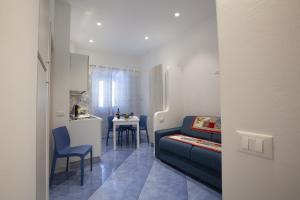 a living room with a couch and a small kitchen at Al Baglio in Castellammare del Golfo +22 photos