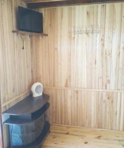 a room with a wooden wall with a shelf and a fan at Цвіт лілії in Szack