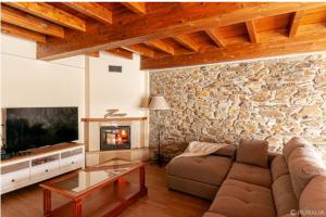 a living room with a couch and a fireplace at Casa Hortensia in Salas