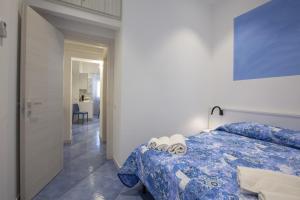 a bedroom with a bed with towels on it at Al Baglio in Castellammare del Golfo