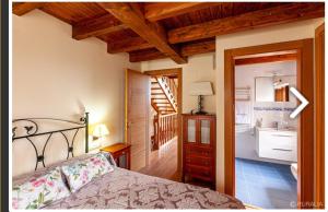 a bedroom with a bed and a bathroom with a sink at Casa Hortensia in Salas