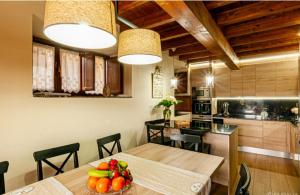 a kitchen and dining room with a table with fruit on it at Casa Hortensia in Salas