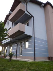 ein Haus mit blauen Streifen auf der Seite in der Unterkunft Apartments Trpenoski in Ohrid