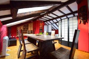a dining room with a wooden table and chairs at Apartamento Loft in Navia