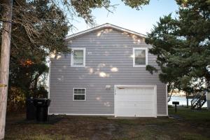 a gray house with a white garage at 57218 Island Club Lane Home in Hatteras