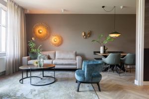 a living room with a couch and a table and chairs at BizStay Maurits in The Hague