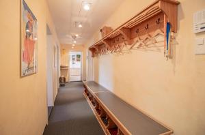 a hallway with a long bench in a room at Sans Souci EG in Arosa