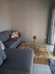 a living room with a couch and a coffee table at 19 Mirabelle Place in Pietermaritzburg