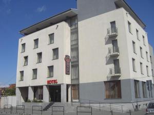 a white building with a sign on it at Hotel Regal in Braşov