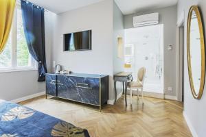 a bathroom with a vanity and a mirror at Le Clos du Cèdre in Saint-Ouen