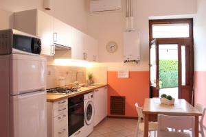 a kitchen with a stove top oven next to a table at Il Turrione in Assisi +17 photos