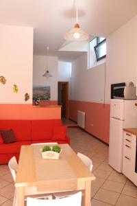 a living room with a red couch and a table at Il Turrione in Assisi