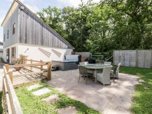 a patio with a table and chairs in a yard at The Outlook in Taunton