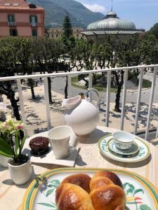 a table with a plate of pastries on a balcony at Stella Marina Stabia in Castellammare di Stabia