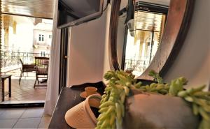 a hat sitting on a couch in front of a mirror at Hotel Acropol in Parga