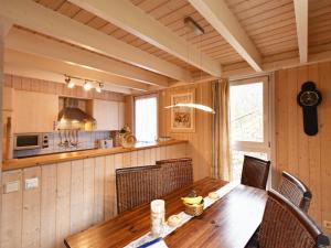 a kitchen with a wooden table and chairs at Ferienhaus Ostseeblick 274 in Baabe