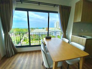 a dining room with a table and a large window at La Habana Hua Hin 2 Bedroom Seaview in Hua Hin