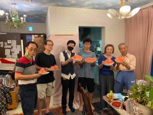 people standing around a kitchen table at Tokyo Guest House 2020 in Tokyo