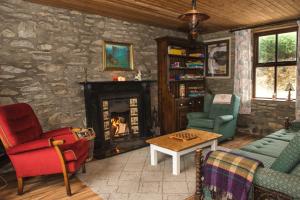 a living room with a stone wall with a fireplace at Hillside View Holiday Home in Killarney