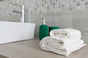 a pile of towels sitting on a counter in a bathroom at A casa di Luca B&B in Torchiara +24 photos