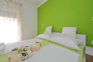 Postel nebo postele na pokoji v ubytování Apartments Nikić