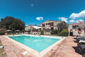a house with a pool and a pool table in front of it at La Melosa Resort & Spa in Roccastrada