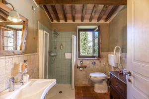 a bathroom with a toilet a sink and a tub at La Melosa Resort & Spa in Roccastrada