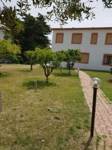 a brick path in front of a building with trees at Su Poeta in Budoni