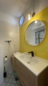 a bathroom with a sink and a mirror at Apartamentos El Caserio in Suances +54 photos