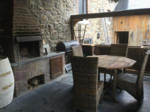a patio with a table and chairs and a fireplace at Maison Druyard huis met 5 slaapkamers in Durbuy