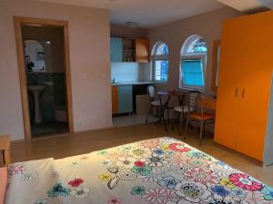 a bedroom with a bed with a flowered blanket on it at Vila Anastas in Ohrid +56 photos