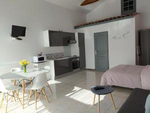 a kitchen and living room with a table and chairs at Domaine Moulin D' Elemiah in Gémozac