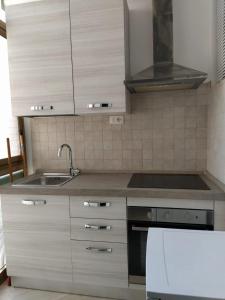 a kitchen with a sink and a stove top oven at la casa di sara in Quartu SantʼElena +1 photo
