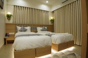 Letto o letti in una camera di Hotel Elysian Residency
