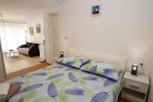 a bedroom with a bed and a living room at Apartment Luigi in Poreč